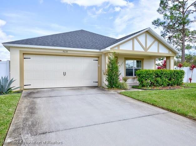 view of front of house featuring an attached garage, a shingled roof, driveway, stucco siding, and a front lawn