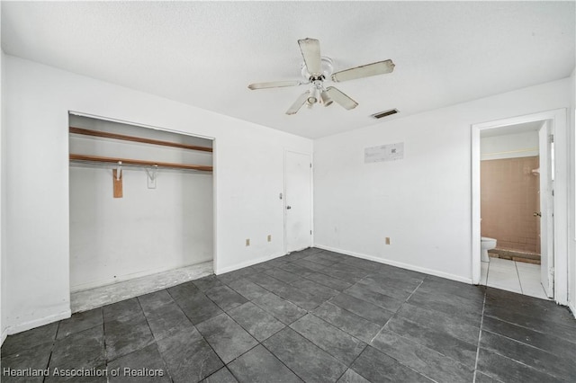 unfurnished bedroom featuring ceiling fan, a closet, and ensuite bathroom