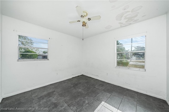 unfurnished room with ceiling fan