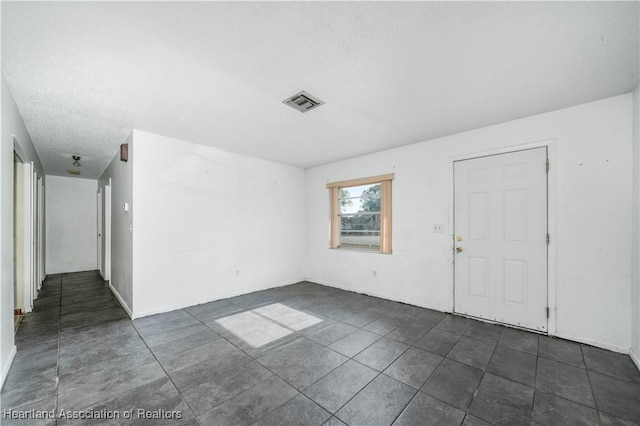 empty room with a textured ceiling