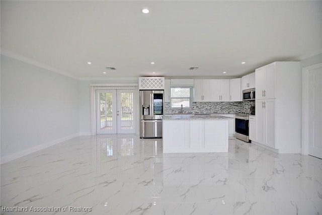 kitchen featuring french doors, white cabinets, sink, ornamental molding, and appliances with stainless steel finishes