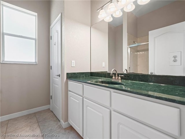 897 Entrance Rd, Avon Park, FL 33825 - bathroom featuring a stall shower, vanity, baseboards, and tile patterned floors
