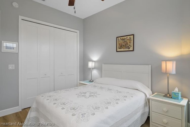 bedroom with ceiling fan, light wood-type flooring, and a closet