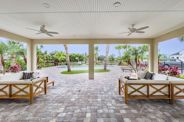 view of patio with an outdoor living space and ceiling fan