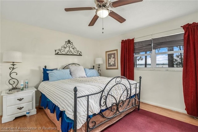 bedroom featuring hardwood / wood-style flooring and ceiling fan