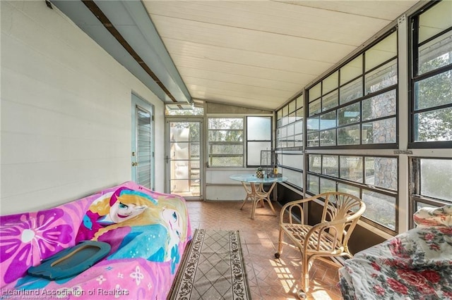 sunroom with vaulted ceiling with beams