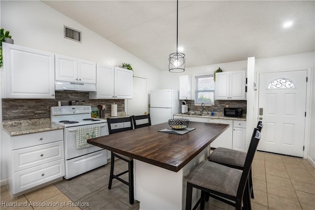 kitchen with white cabinetry, lofted ceiling, wooden counters, and white appliances