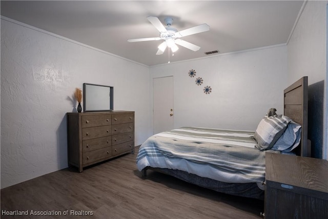 bedroom with ceiling fan, dark wood-type flooring, and ornamental molding