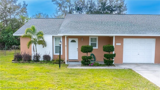 view of front facade with a garage and a front yard