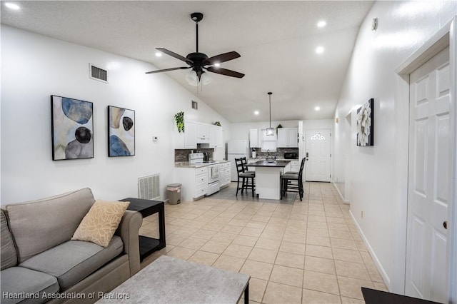 living room featuring high vaulted ceiling, light tile patterned floors, and ceiling fan