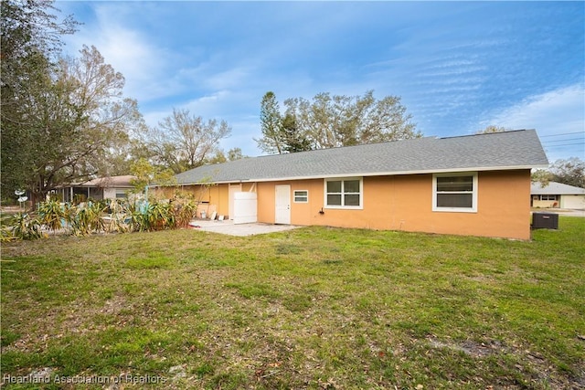 back of property featuring a lawn and a patio