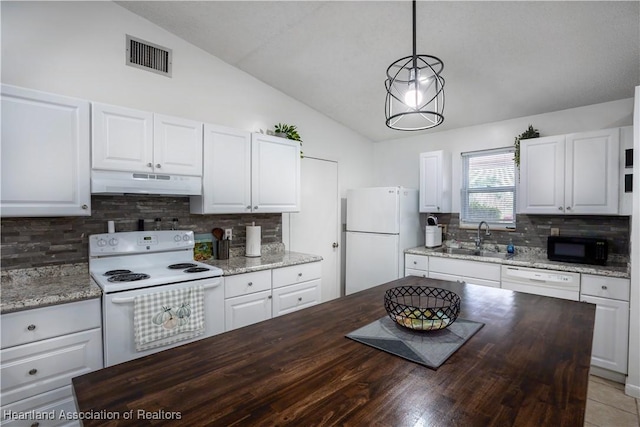 kitchen featuring lofted ceiling, white cabinets, hanging light fixtures, and white appliances