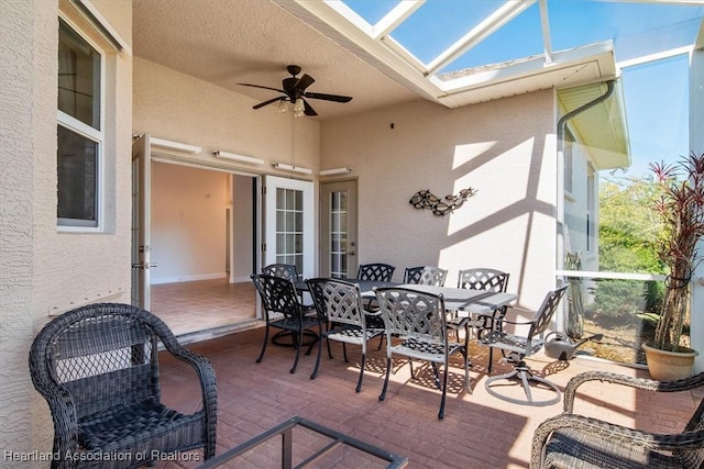view of patio with a lanai, ceiling fan, and outdoor dining area