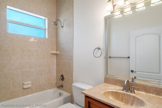 bathroom featuring toilet, shower / bath combination, and vanity
