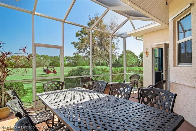 sunroom featuring outdoor dining area