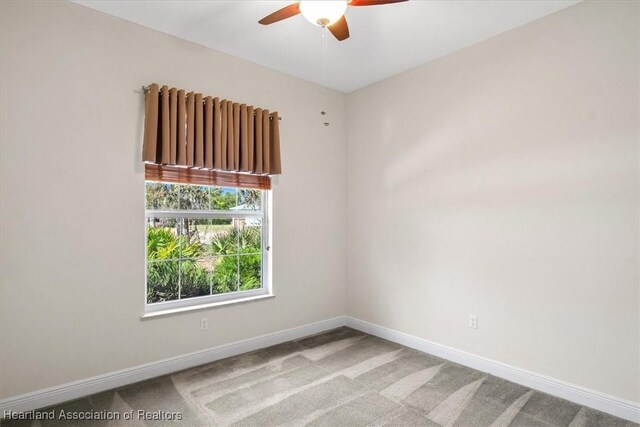 empty room featuring a ceiling fan, carpet floors, and baseboards