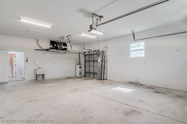 garage with a sink, electric water heater, and a garage door opener