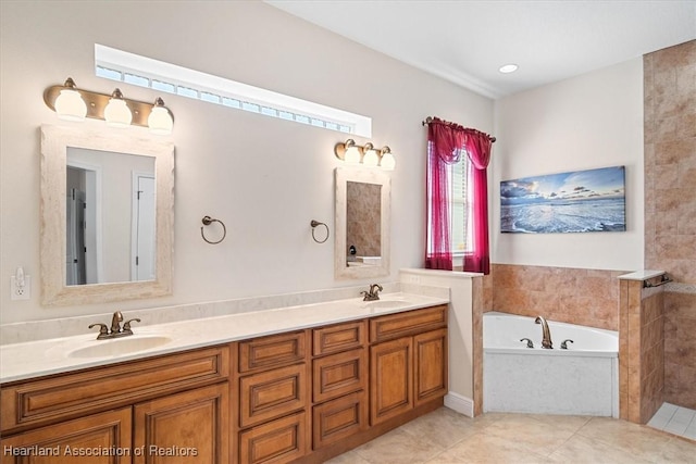 bathroom with tile patterned floors, a sink, double vanity, and a garden tub