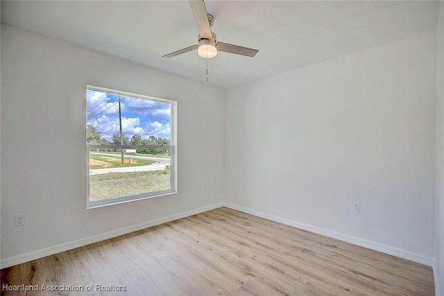 spare room with light hardwood / wood-style flooring and ceiling fan