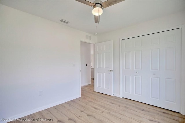 unfurnished bedroom with light wood-type flooring, a closet, and ceiling fan