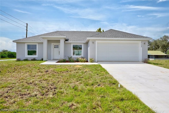 single story home with a front yard and a garage