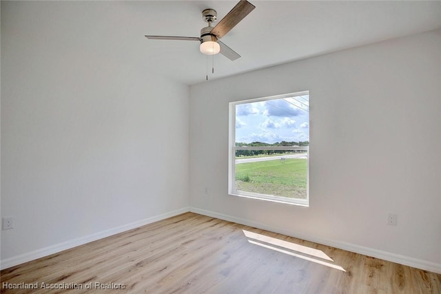 empty room featuring light hardwood / wood-style floors, plenty of natural light, and ceiling fan