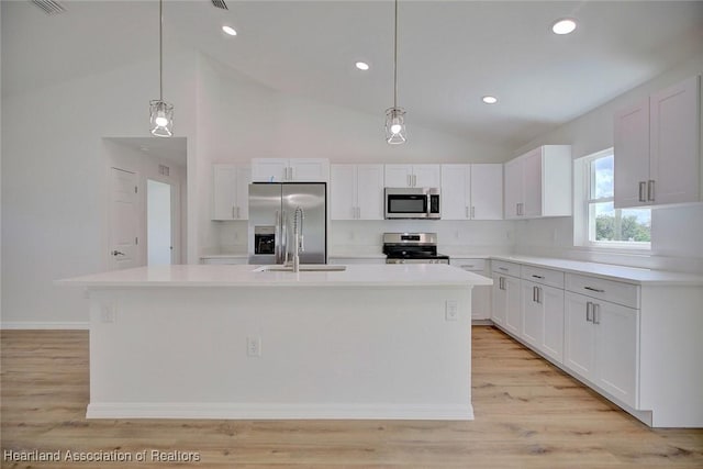 kitchen featuring white cabinets, a kitchen island, and stainless steel appliances