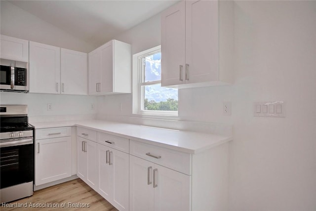 kitchen featuring white cabinets, light hardwood / wood-style floors, and stainless steel appliances