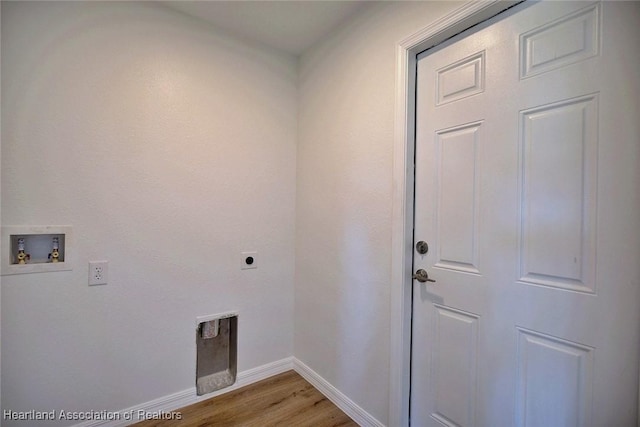 washroom with hookup for an electric dryer, washer hookup, and light hardwood / wood-style flooring