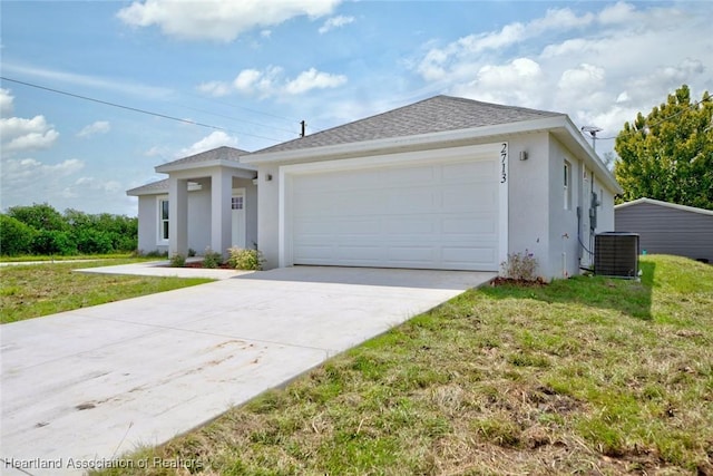 view of front facade featuring central air condition unit, a front yard, and a garage