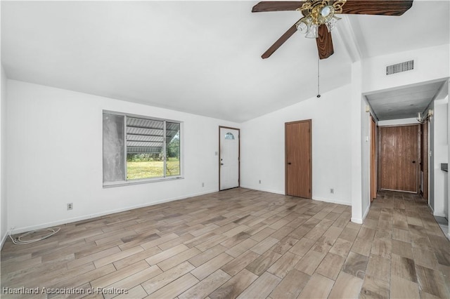 unfurnished living room featuring ceiling fan, vaulted ceiling, and light hardwood / wood-style flooring