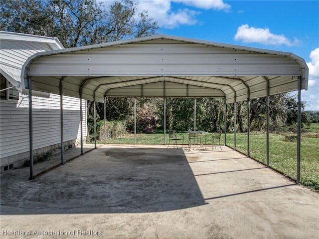 view of vehicle parking featuring a carport and a yard