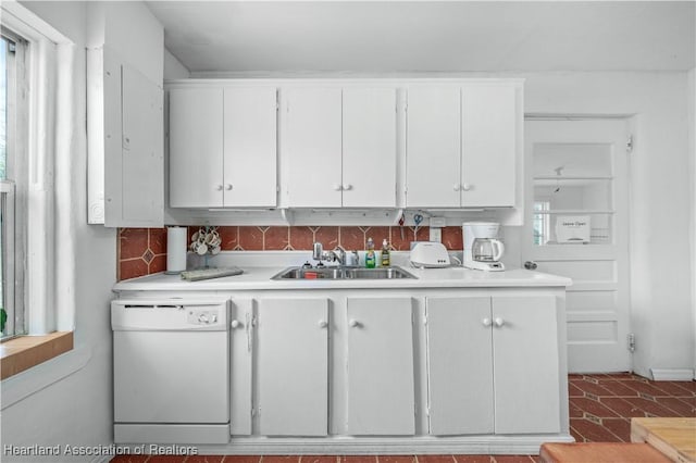 kitchen featuring dishwasher, sink, and white cabinets