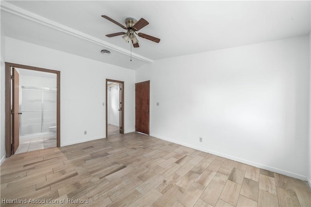 unfurnished room featuring beamed ceiling, ceiling fan, and light wood-type flooring