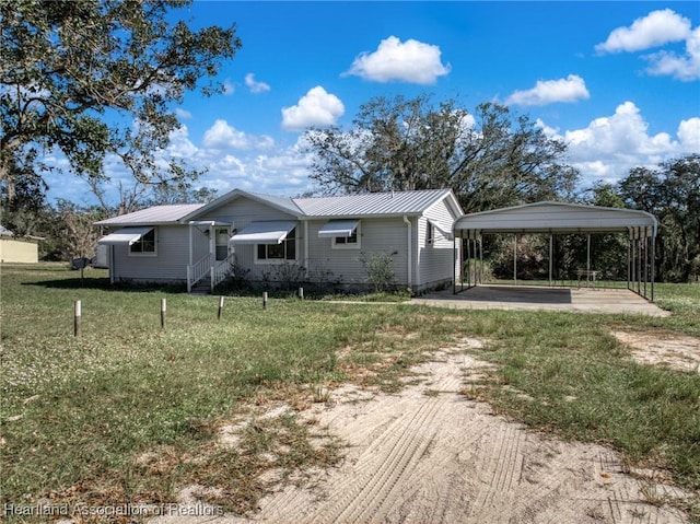 rear view of house with a yard and a carport