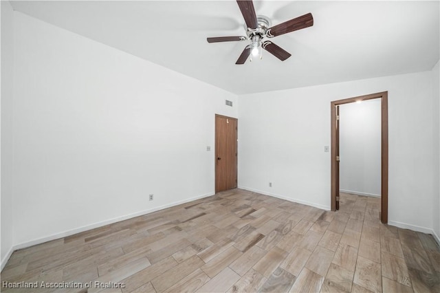 empty room with light hardwood / wood-style floors and ceiling fan