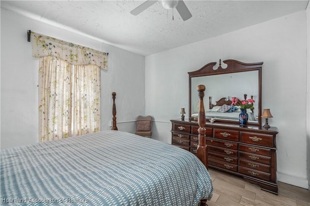 bedroom featuring ceiling fan, a textured ceiling, and light hardwood / wood-style flooring