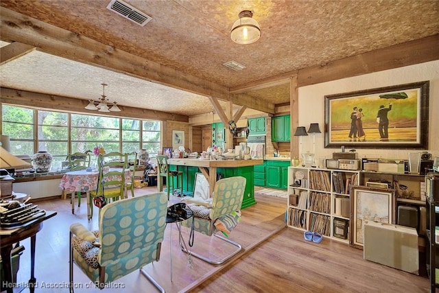 1320 Lakeview Dr, Sebring, FL 33870 - living area with light wood-style floors and a chandelier