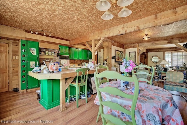 1320 Lakeview Dr, Sebring, FL 33870 - dining room with wooden walls, light wood-type flooring, and rail lighting