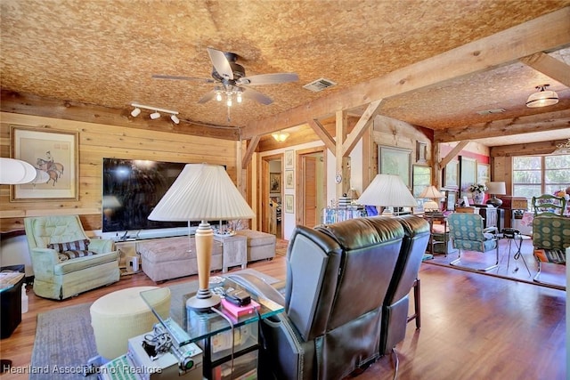 1320 Lakeview Dr, Sebring, FL 33870 - living area with wood walls, wood finished floors, a ceiling fan, and rail lighting
