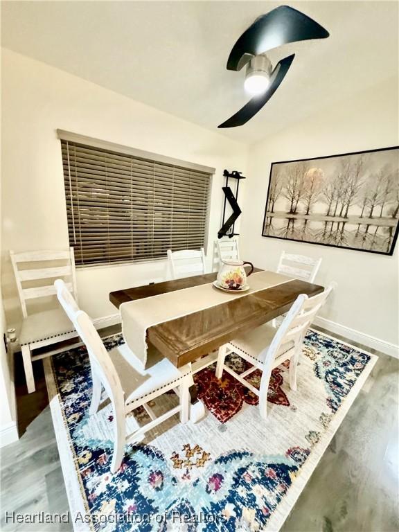 dining room with ceiling fan and hardwood / wood-style floors