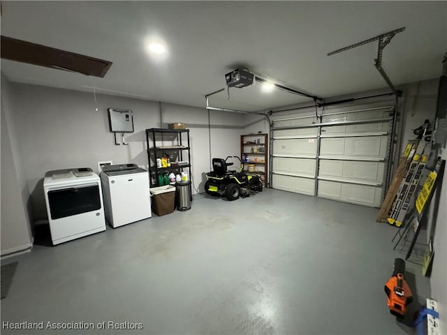 garage featuring refrigerator, a garage door opener, and independent washer and dryer