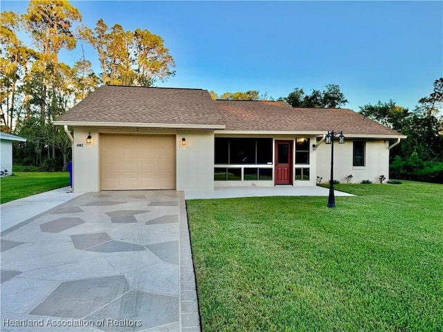 ranch-style house with a garage and a front yard