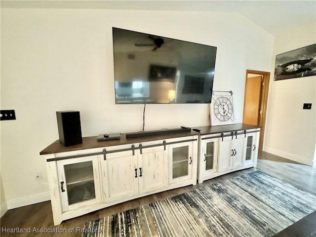 living room featuring lofted ceiling and dark wood-type flooring