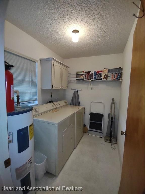160 Parkview Cir, Lake Placid, FL 33852 - washroom with water heater, cabinet space, washing machine and dryer, and a textured ceiling