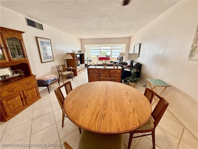 2131 Lakeview Dr Unit 308, Sebring, FL 33870 - dining area featuring light tile patterned floors, baseboards, a textured ceiling, and visible vents