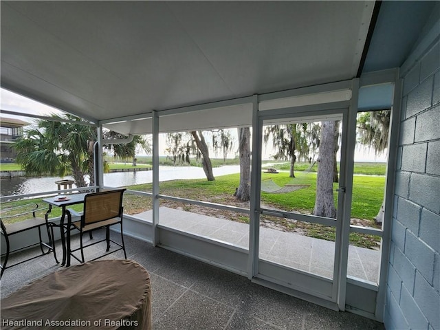 sunroom / solarium with a water view