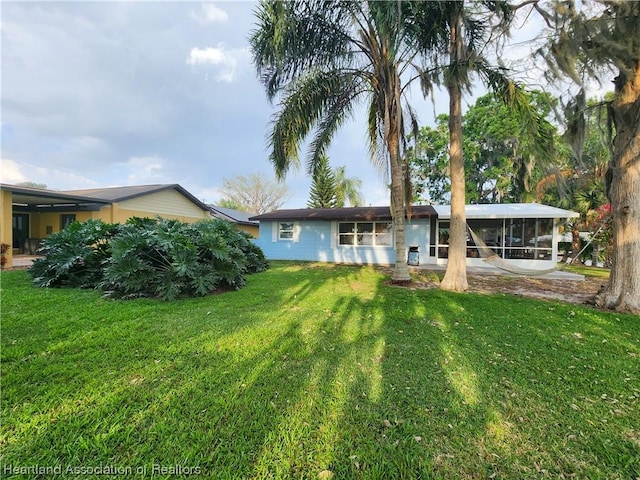 back of property featuring a lawn