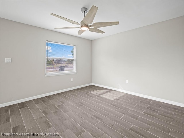 spare room featuring ceiling fan and dark hardwood / wood-style floors