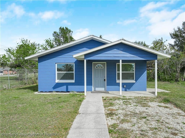 bungalow-style home with a front yard